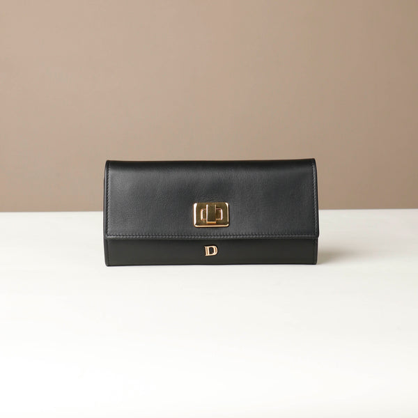 Front view of the Danilos Leather jewelry organizer Mishka in black with gold accents in a beige background