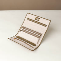 Front view of the Danilos Leather jewelry organizer Mishka in green with gold zipper and organizers in a beige background