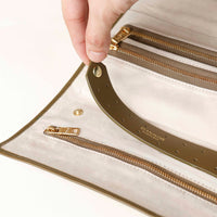 close-up view of the Danilos Leather jewelry organizer Mishka in green with zipper in a beige background