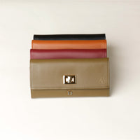 Front view of a green, red, brown and black danilos leather jewelry organizer mishka in a white background