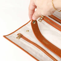 close-up view of the Danilos Leather jewelry organizer Mishka in brown with gold zippers in a beige background