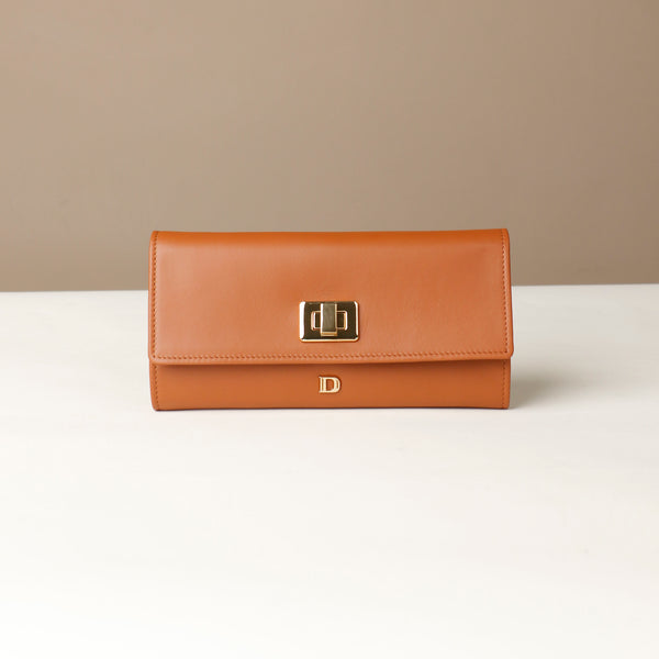 Front view of the Danilos Leather jewelry organizer Mishka in brown with gold accents in a beige background