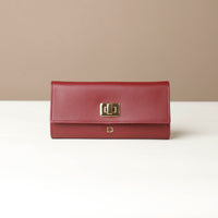 Front view of the Danilos Leather jewelry organizer Mishka in red with gold accents in a beige background