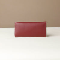 Back view of the Danilos Leather jewelry organizer Mishka in red in a beige background