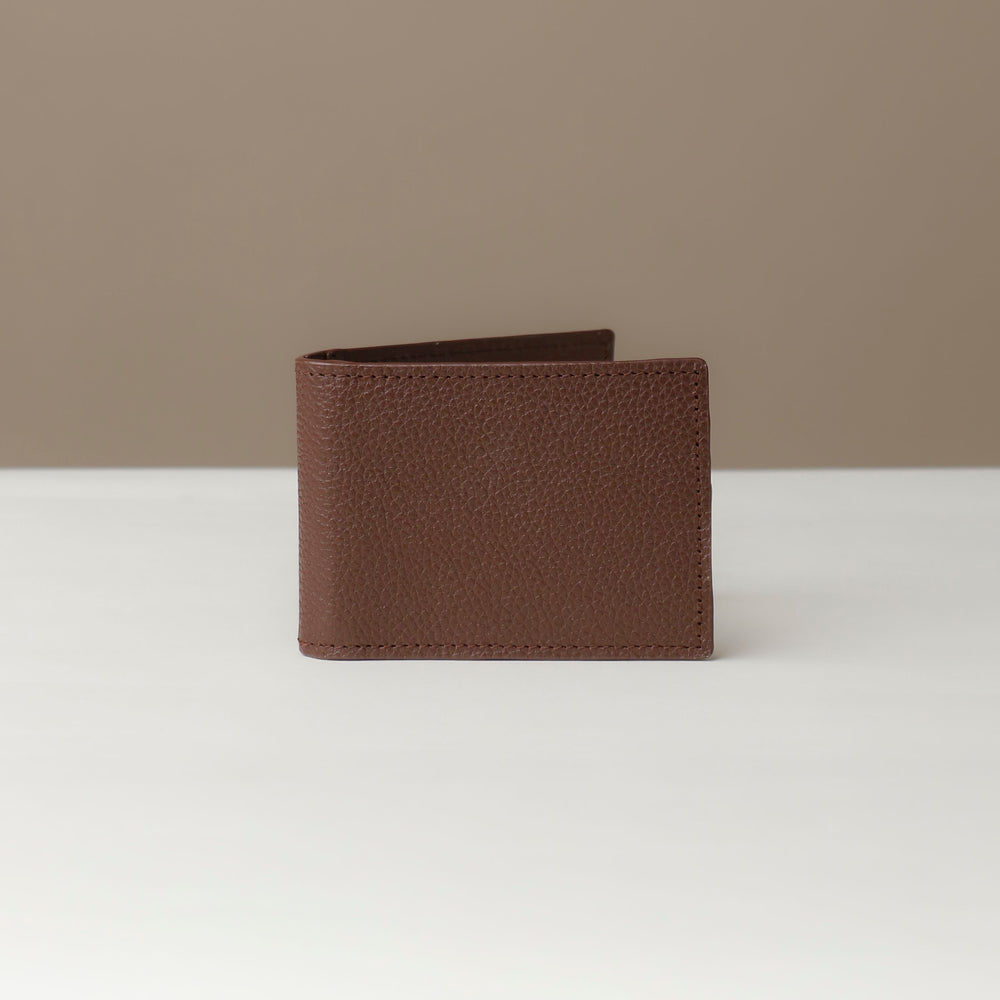 Front view of a Danilos pebble brown leather money clip Steven, in a beige and white background