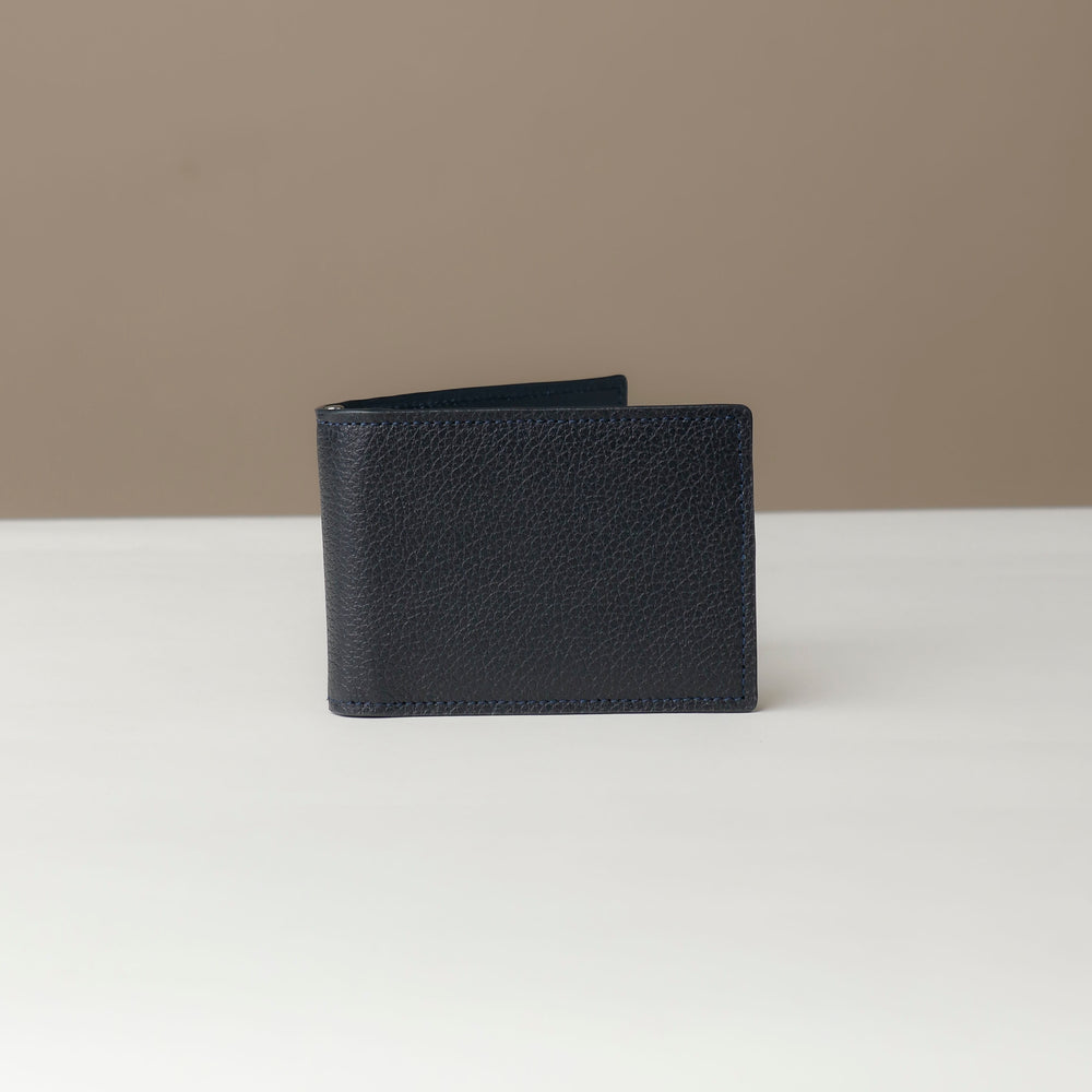 Front view of a Danilos pebble marine blue leather money clip Steven, in a beige and white background