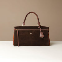 Brown suede leather Danilos handbag with gold accents on a beige background