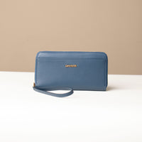 front view of a blue Danilos wallet Carlota with a visible handle drop in a beige background