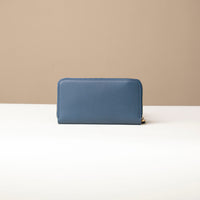 back view of a blue Danilos wallet Carlota in a beige background