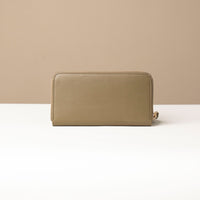 Back view of a green Danilos wallet Carlota in a beige background
