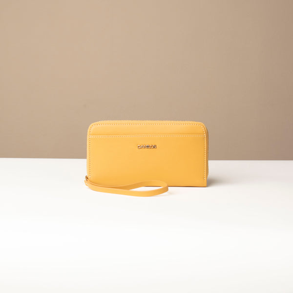 front view of a Yellow Danilos wallet Carlota with a visible handle drop in a beige background
