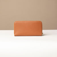 back view of a light brown Danilos wallet Carlota in a beige background
