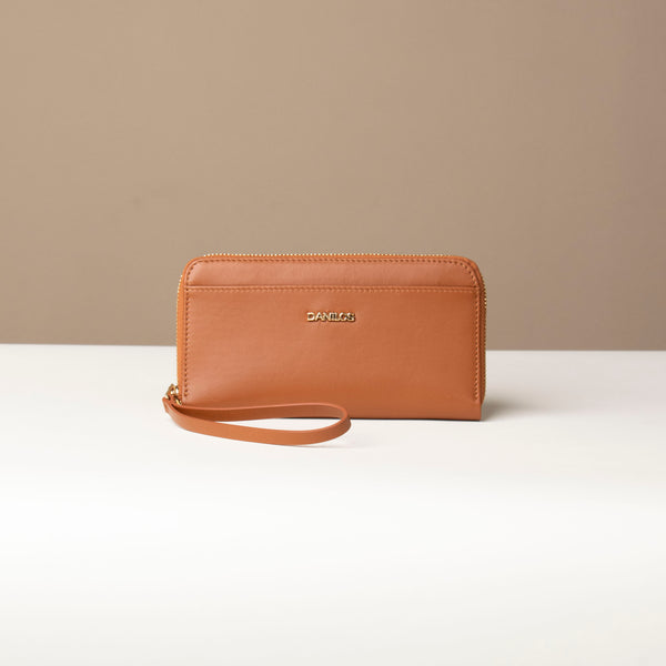 front view of a light brown Danilos wallet Carlota with a visible handle drop in a beige background